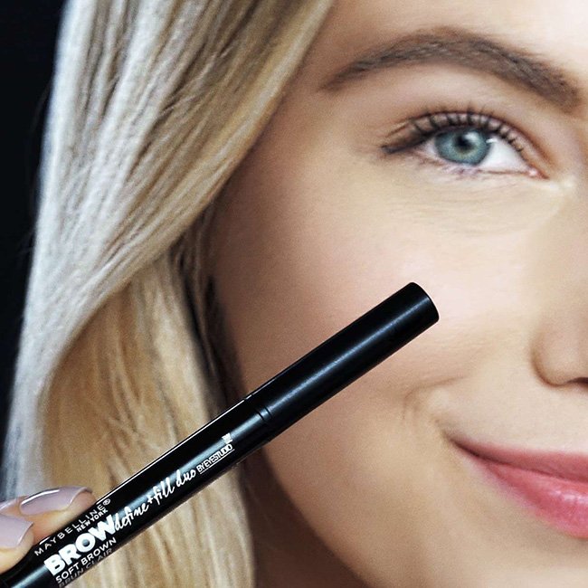 Model holding the Maybelline Brow Define and fill duo product