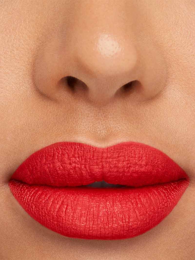 Close up of lips with coral lipstick on