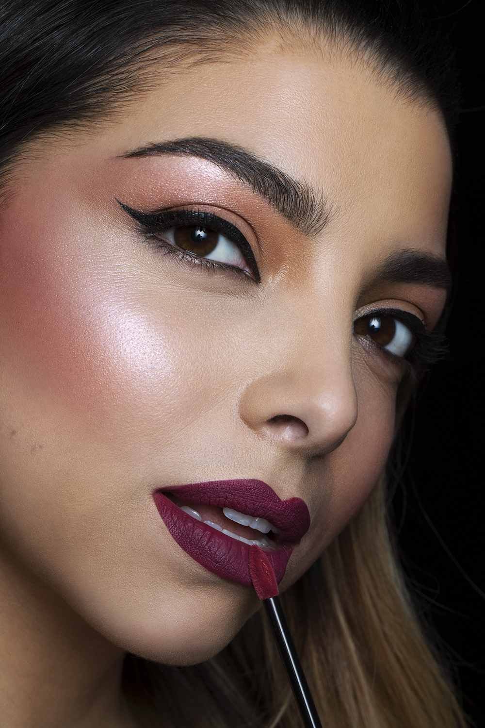 Model putting on lipstick